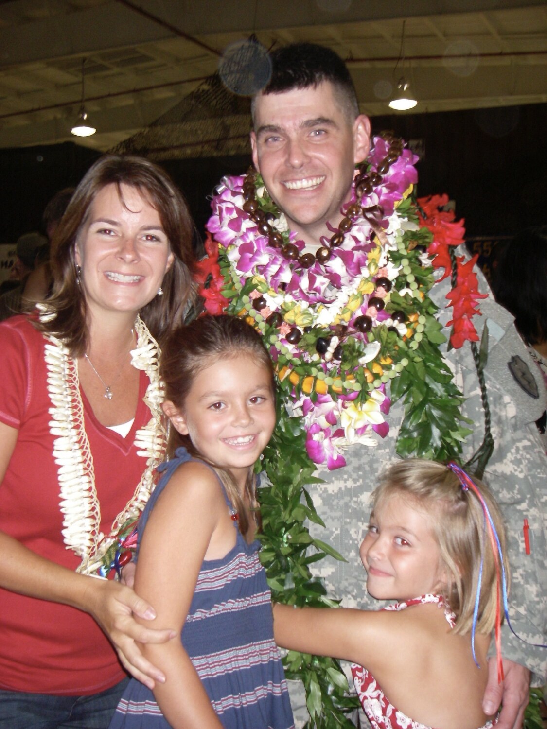 Steve Sigloch in Army uniform with his wife and two daughters