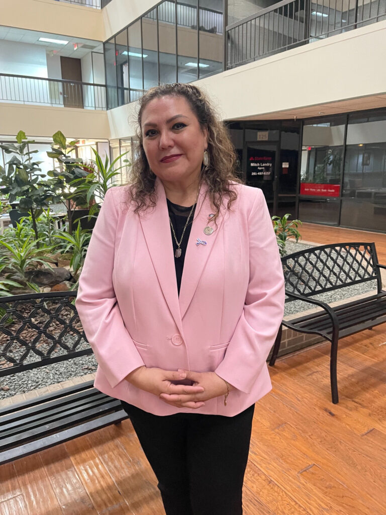 Esmeralda Leon: Finding the Strength to Begin Again Esmeralda Leon wearing a pink blazer in an indoor atrium.