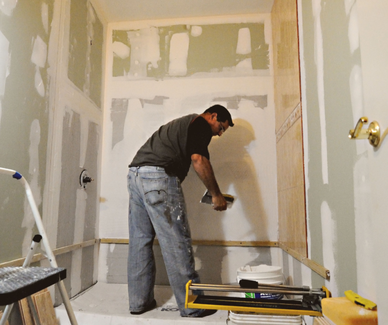 When the Lowest Bid Costs More: Alexander Barrios on Choosing Construction Value Worker remodeling a bathroom with unfinished walls and tools.
